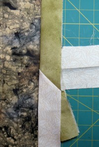 Testing the stitched seam against the quilt edge