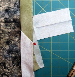 Test the pinned seam line by folding it in place along the quilt edge.  It should lay flat except for the extra fabric inside the fold