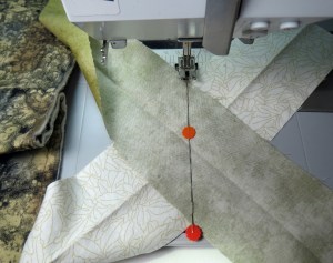 Sew along the marked line, carefully removing the pins as you sew (or put additional pins to the side)