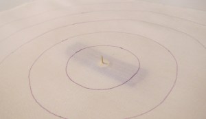 Thumbtack through center from the front