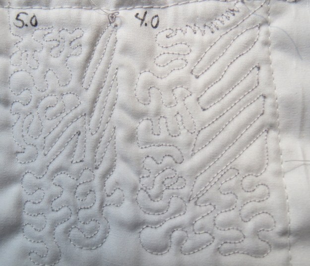 Back side of Mettler tension test sampler, for 4.0 and 5.0 thread tensions, showing the gray top thread coming through