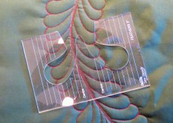 feather template placed on stitched out design